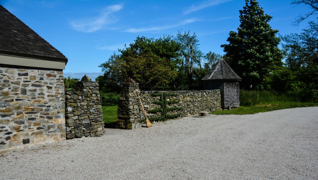 Sakonnet Garden. Little Compton, RI Designed and Maintained by John Gwynne and Mikel Folcarelli Entrance to the residence. Espalier on stacked stone wall with shaker shingles Thinkingoutsidetheboxwood.com