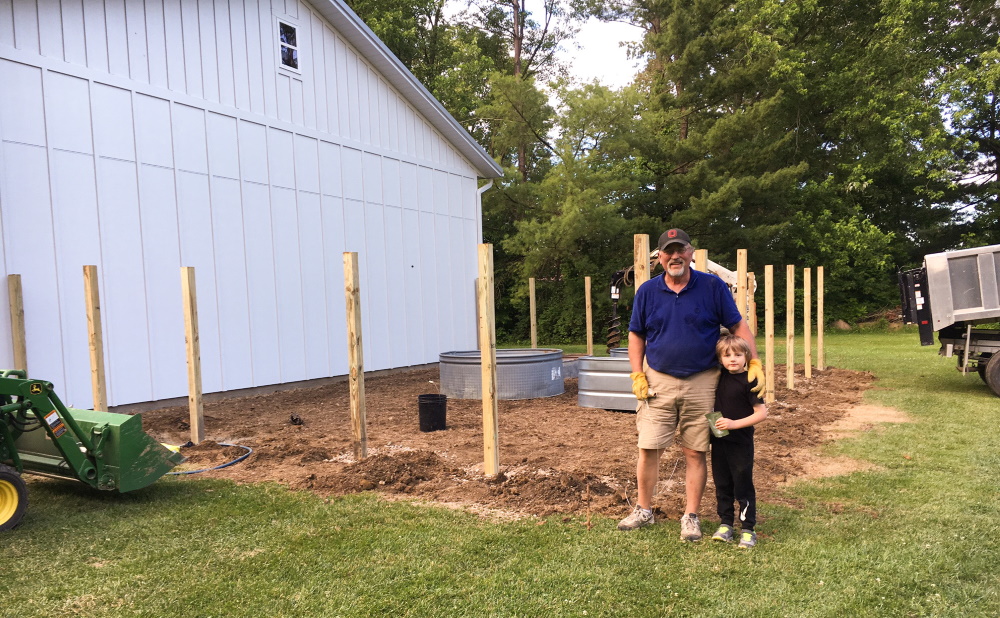 Our fenced vegetable garden during construction Thinking Outside the Boxwood