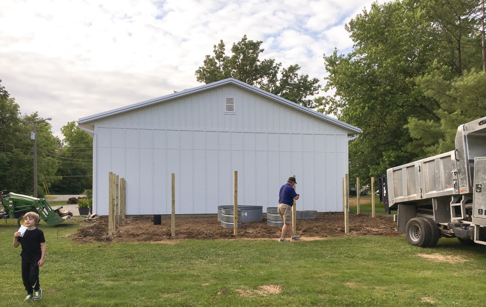 Our fenced vegetable garden during construction Thinking Outside the Boxwood