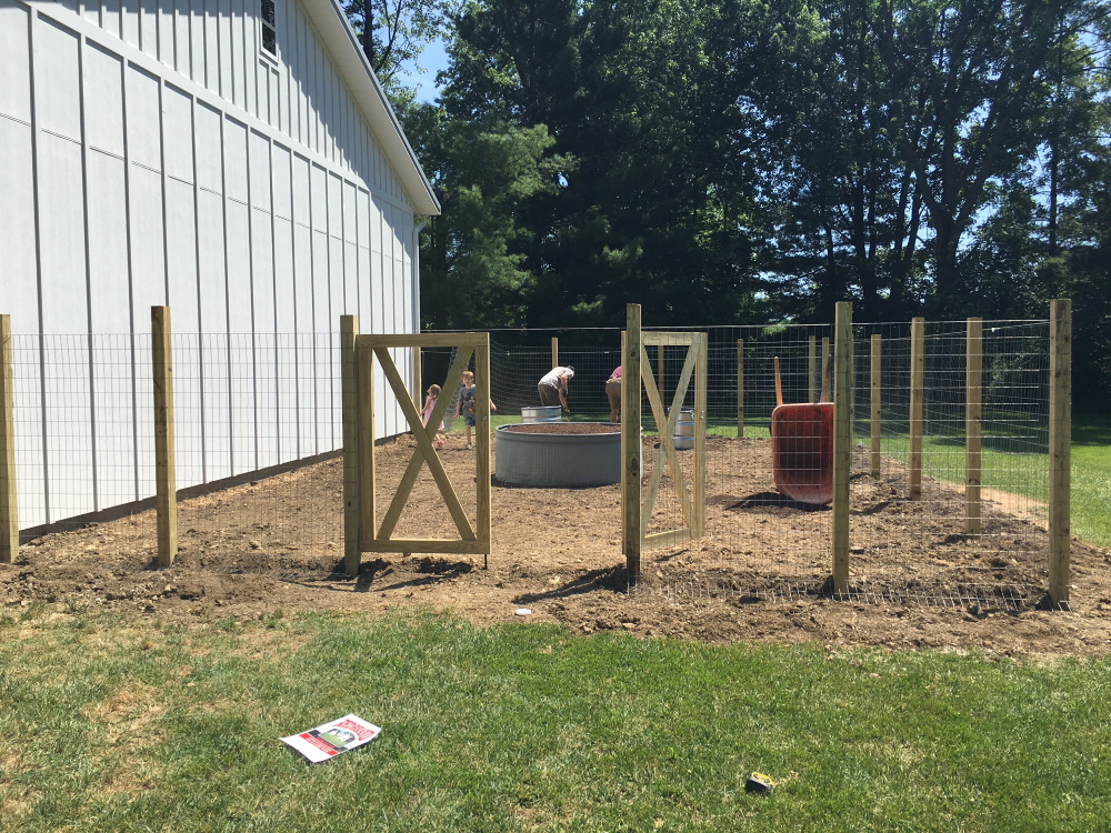 Our fenced vegetable garden during construction Thinking Outside the Boxwood